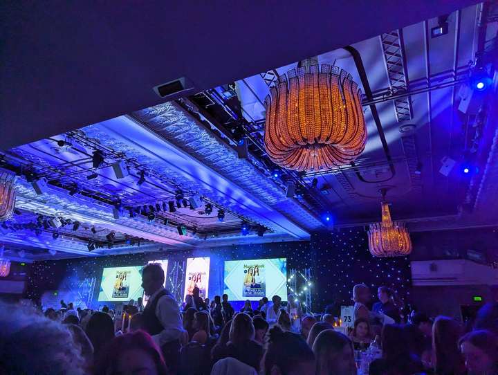 Interior of the Women in Music Awards 2024 ballroom, Music Week branded stage screens