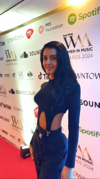 On the Women in Music Awards 2024 red carpet, sponsor step-and-repeat backdrop